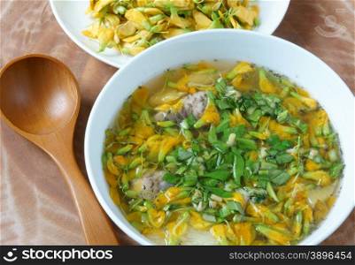 Vietnamese food, sour fish vegetable soup, ingredients as fish, pineapple, tamarind, coriander, common sesban or bong dien dien, this nutrition eating is specific of Mekong Delta, Vietnam on summer