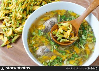 Vietnamese food, sour fish vegetable soup, ingredients as fish, pineapple, tamarind, coriander, common sesban or bong dien dien, this nutrition eating is specific of Mekong Delta, Vietnam on summer