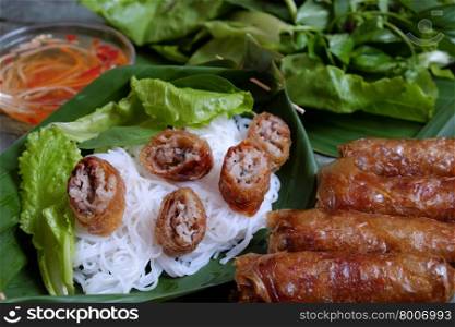 Vietnamese food, spring roll or cha gio, a delicious fried food with cylinder shape, eat with bun, salad and fish sauce, this also rich calories, cholesterol, fatty food, popular Vietnam eating