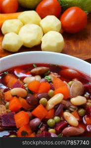 Vietnamese food, vegetable soup, fresh ingredients: potato, green pea, carrot, red bean, white bean, pork pone, raw material stew in water, season with scallion, is popular dish in Vietnam meal