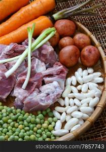 Vietnamese food, vegetable soup, fresh ingredients: potato, green pea, carrot, red bean, white bean, pork pone, raw material stew in water, season with scallion, is popular dish in Vietnam meal