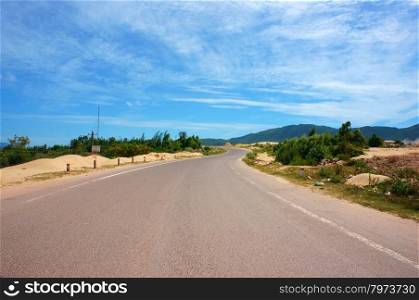 Vietnamese highway, cross sand hill, jungle, countryside or mountain, route for travel, discovery Vietanam, landscape of rural under blue sky on day