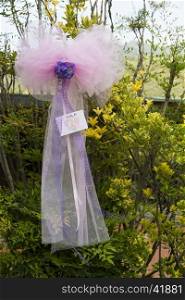 View a pink ribbon as a decoration for a baptism