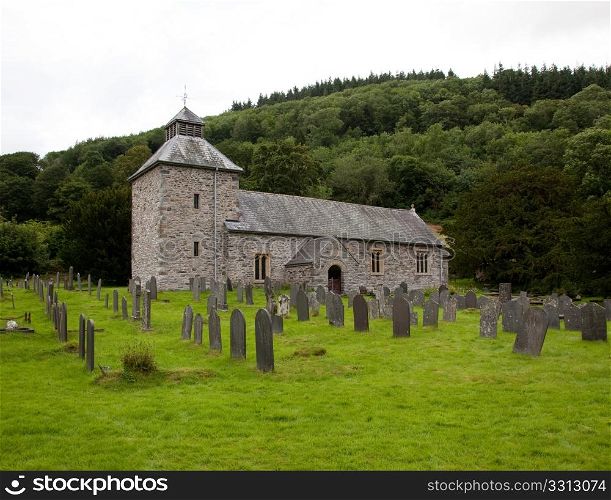 View across Graveyard to old stone church in north Wales