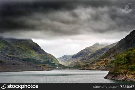 View along Llanberis Pass towards Glyder Fawr on left and Snowdon on right on cloudy overcast day
