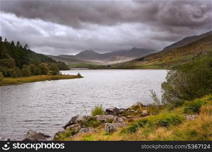 View along Llyyn Mymbyr in Snowdonia National Park toowards cloud coovered Mount Snowdon