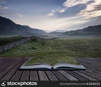 View along misty valley towards Snowdonia mountains. Creative concept pages of book View along countryside fields towards misty Snowdonia mountain range in distance
