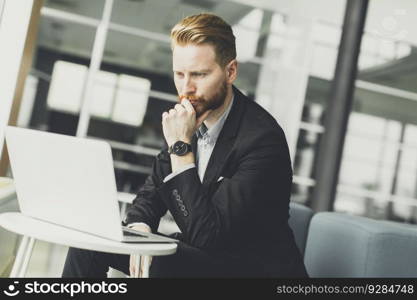 View at attractive businessman typing on his laptop at the office