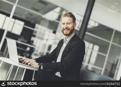 View at attractive businessman typing on his laptop at the office