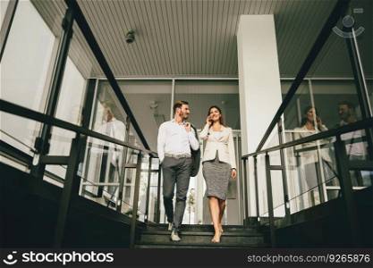 View at business couple coming down the stairs