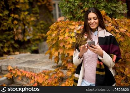View at pretty young woman outdoor with mobile phone