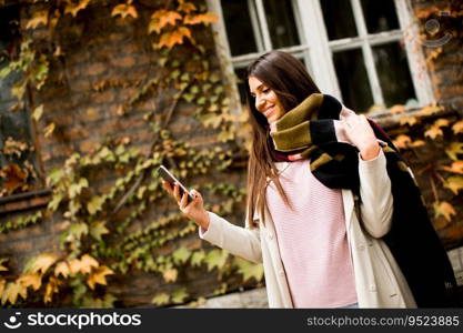 View at pretty young woman outdoor with mobile phone