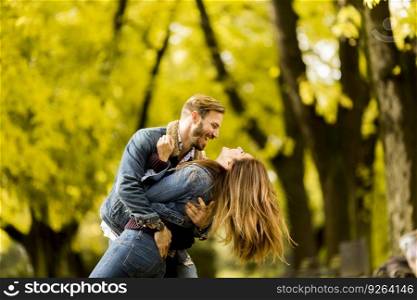 View at smiling couple hugging in autumn park