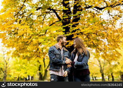 View at smiling couple hugging in autumn park