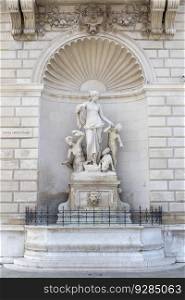 View at statue of Tethys on the Facade of the Lloyd Palace in Trieste, Italy