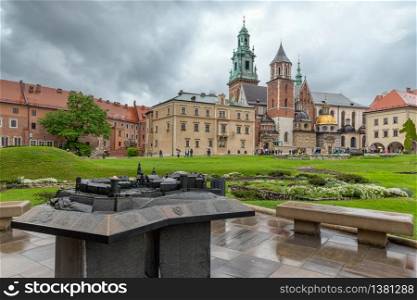 View at Wavel square with medieval buildings and floor plan sculpture during a rainy day in Krakow, Poland. View at Wavel square with medieval buildings in Krakow, Ppland