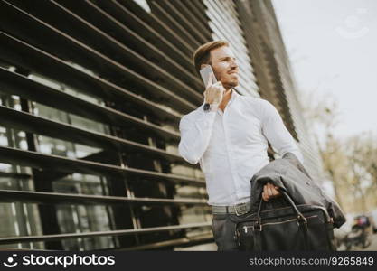 View at Young successful men entrepreneur using mobile phone outdoor