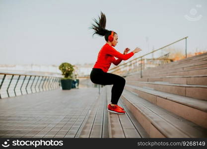 View at young woman exercising jumping outside