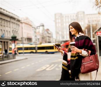 View at young woman hailing a taxi on the street in the city