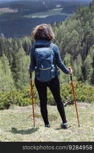 View at young woman hiking in mountain