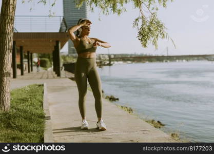 View at young woman with headphones  taking a break during exercising outside