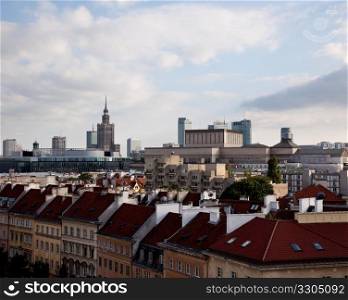 View away from the old town of Warsaw in Poland showing rooftops and Palace of Science and Culture in the distance