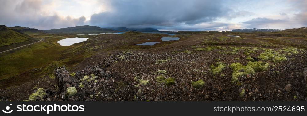 View during auto trip in West Iceland highlands, Snaefellsnes peninsula, Snaefellsjokull National Park. Spectacular volcanic tundra landscape with mountains, craters, lakes, gravel roads.