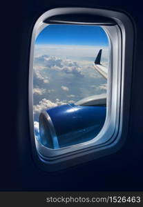 View from a jet plane window high on the blue skies. Flight travel