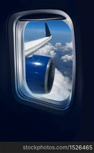 View from a jet plane window high on the blue skies. Flight travel
