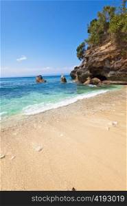 View from a sandy beach on rocks at ocean. Indonesia, Bali