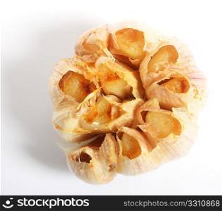View from above of a head of garlic over a white background with a light shadow.