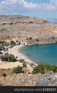 View from above of Lindos Main Beach in Rhodes, one of the Dodecanese Islands in the Aegean Sea, Greece.