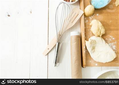 View from above on cookies on dish and kitchen utensils on table