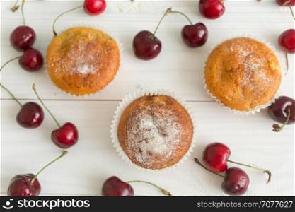 View from above on muffins decorated with fresh cherries