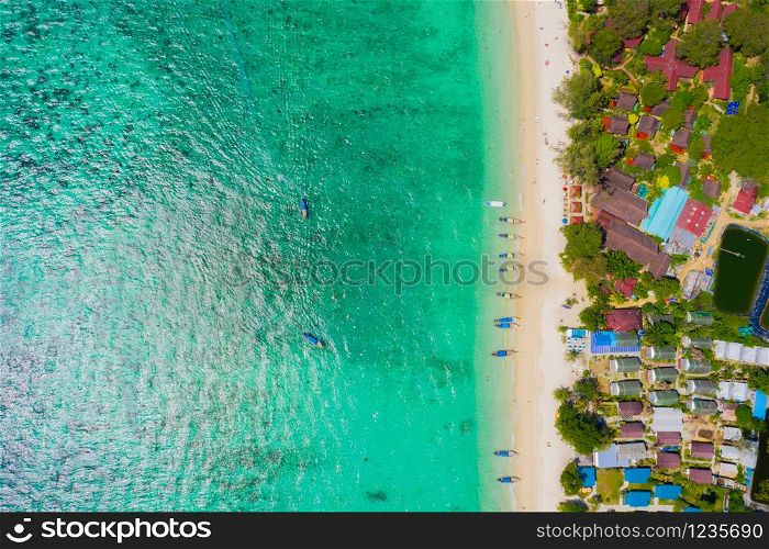View from above, stunning aerial view of a beautiful tropical beach with white sand and turquoise clear water, long-tail boat and people sunbathing,Long beach, Phi Phi Thailand.