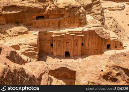 View from above to the ancient tomb of Roman soldier and funeral ballroom carved in sandstone rock in the Wadi Farasa canyon, Petra, Jordan