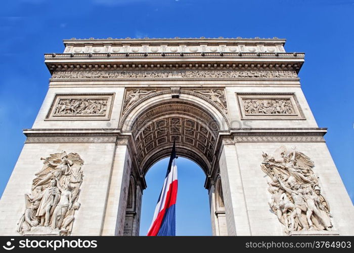 View from Arch of triumph with french flag in Paris, France