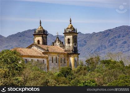 View from behind an old colonial-style church in the historic city of Ouro Preto in Minas Gerais and its mountains. View from behind an old colonial-style church