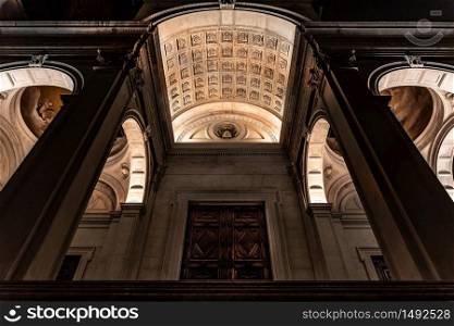 View from below of the main entrance of the Cathedral of Sant&rsquo;Alessandro, the Cathedral of Bergamo Alta illuminated at night. Vertical image