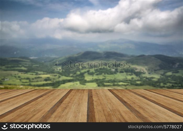 View from Cadair Idris mountain North over countryside landscape. View from Cadair Idris looking North towards Dolgellau over fields and countryside landscape with wooden planks floor