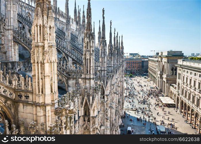 View from roof of Duomo gothic cathedral to piazza square in Milan