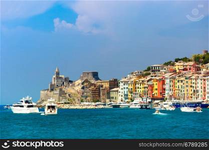 View from sea of colorful picturesque harbour of Porto Venere with Gothic Church of St. Peter, Italian Riviera, Liguria, Italy.