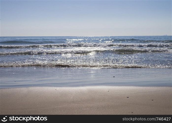 View from seashore of waves on surface of the sea