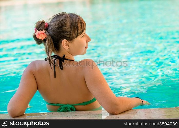 view from the back of a beautiful girl in the pool