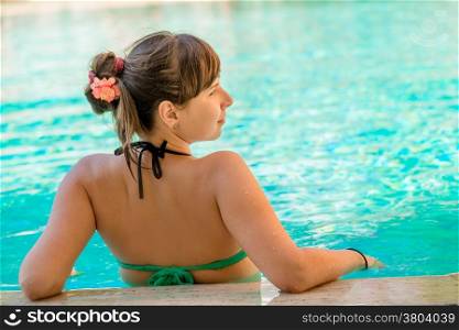 view from the back of a beautiful girl in the pool