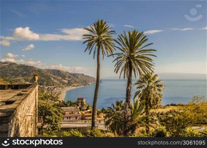 View from the cliffs of the Sicilian coast near the city of taormina with its vegetation and constructions