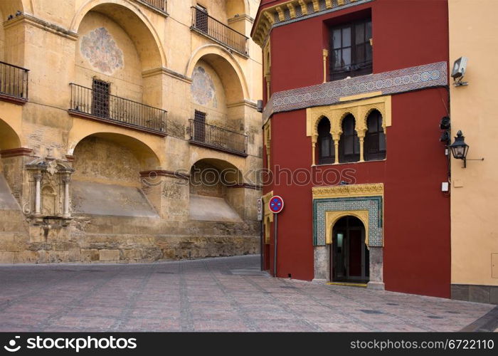 View from the Plaza del Triunfo on the Mezquita Cathedral historic facade and Mudejar style building in Old Town of Cordoba, Spain.