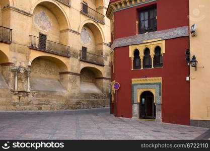 View from the Plaza del Triunfo on the Mezquita Cathedral historic facade and Mudejar style building in Old Town of Cordoba, Spain.