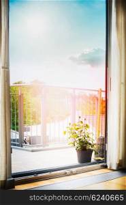 View from the room on the balcony or the terrace with roses flowers pot, drapes and Beautiful sky. Home scene