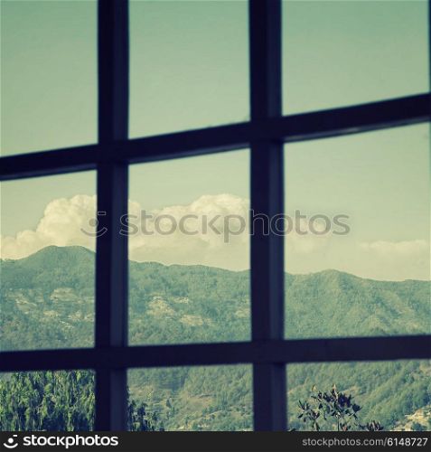 View from the window to mountains and sky with clouds